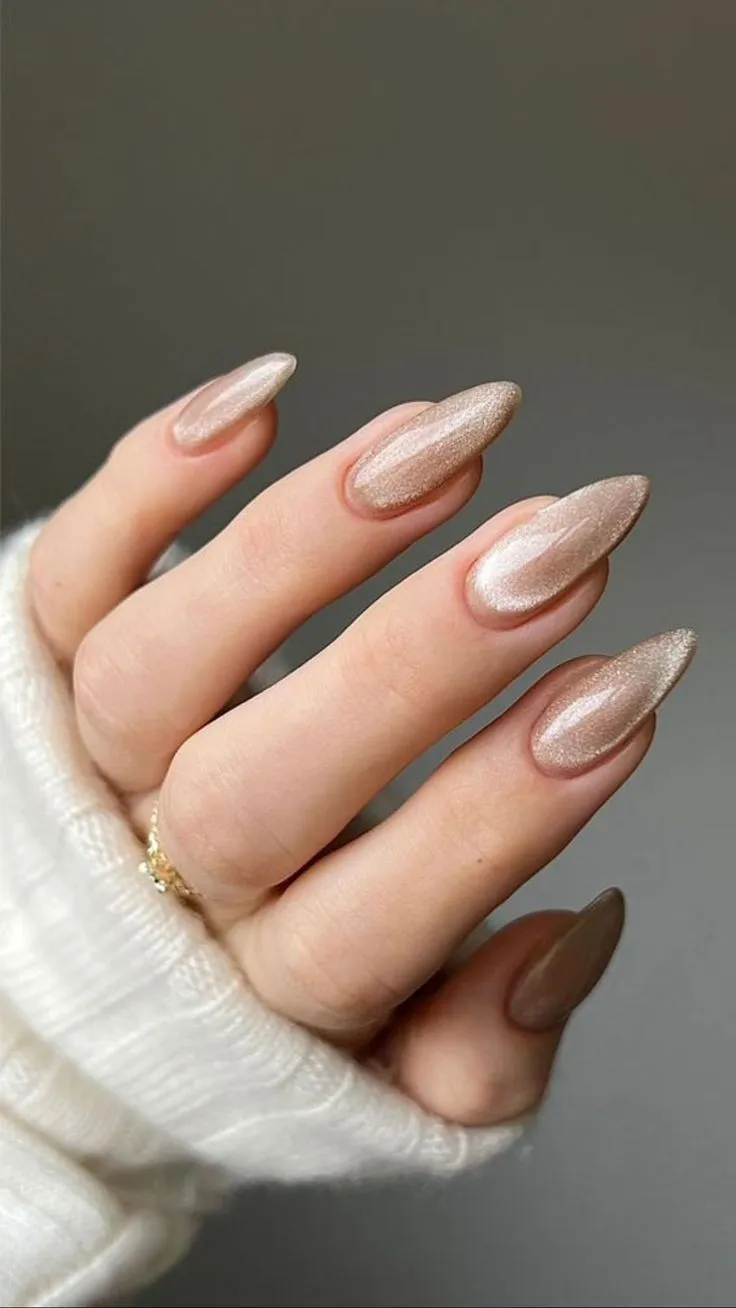 https://www.stoleninspiration.com/wp-content/uploads/2025/04/almond-cateye-neutral-beige-nail-art-0.jpg