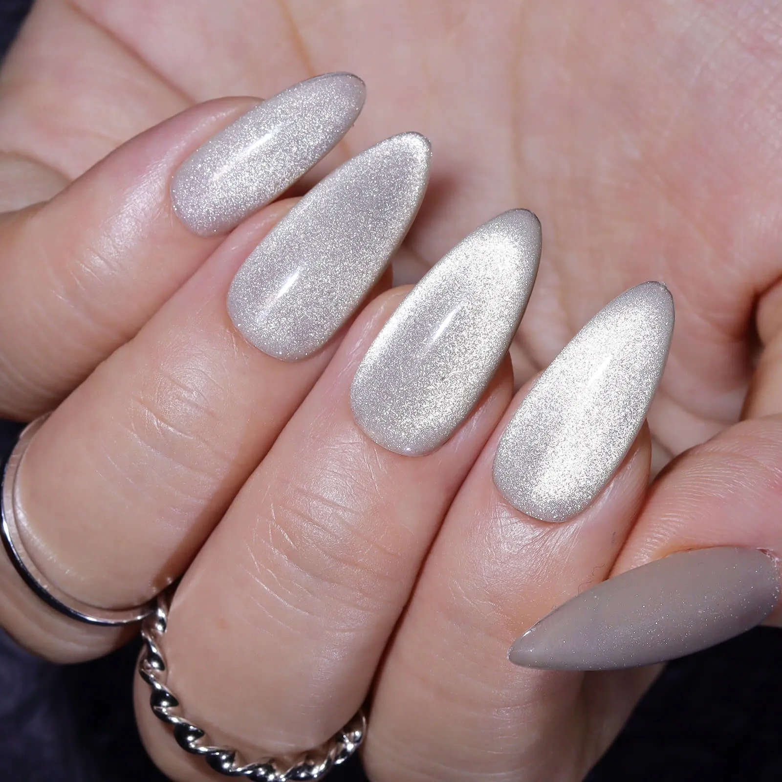 https://www.stoleninspiration.com/wp-content/uploads/2025/04/white-cat-eye-manicure-almond-nails-0.jpg