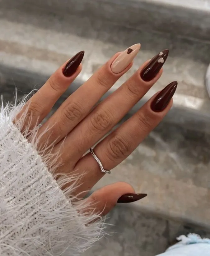 https://www.stoleninspiration.com/wp-content/uploads/2025/09/Dark-brown-stilleto-nails-with-mini-heart-accents-fall-winter-manicure.jpg