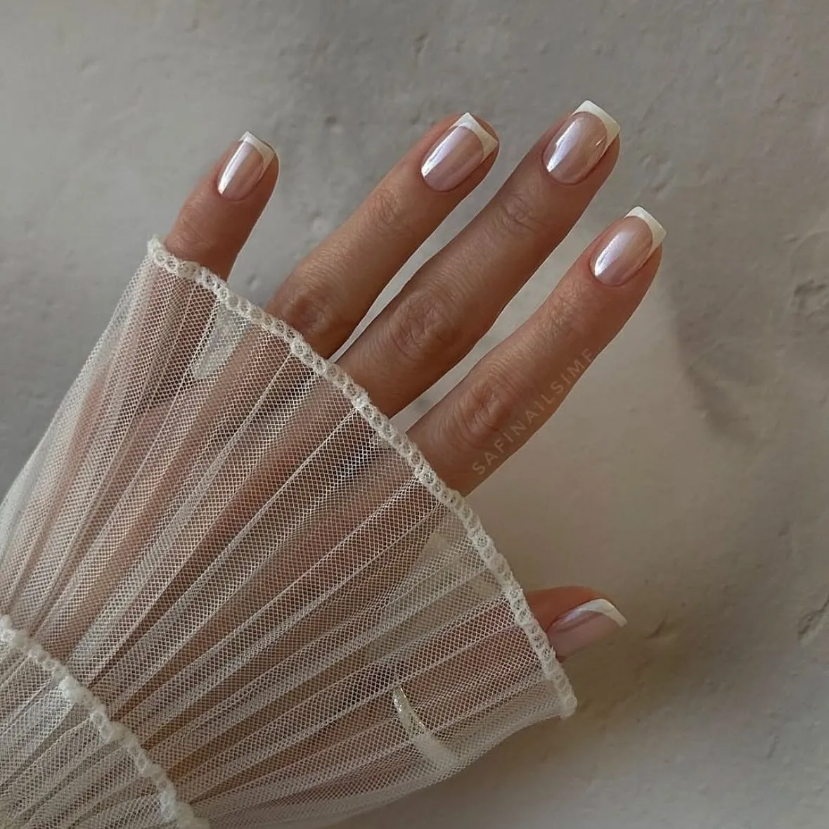vanilla french tip nails with clear chrome base