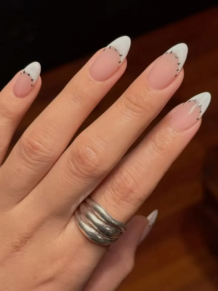 elegant summer french tip nail designs with white tips and silver bead detail on almond nails